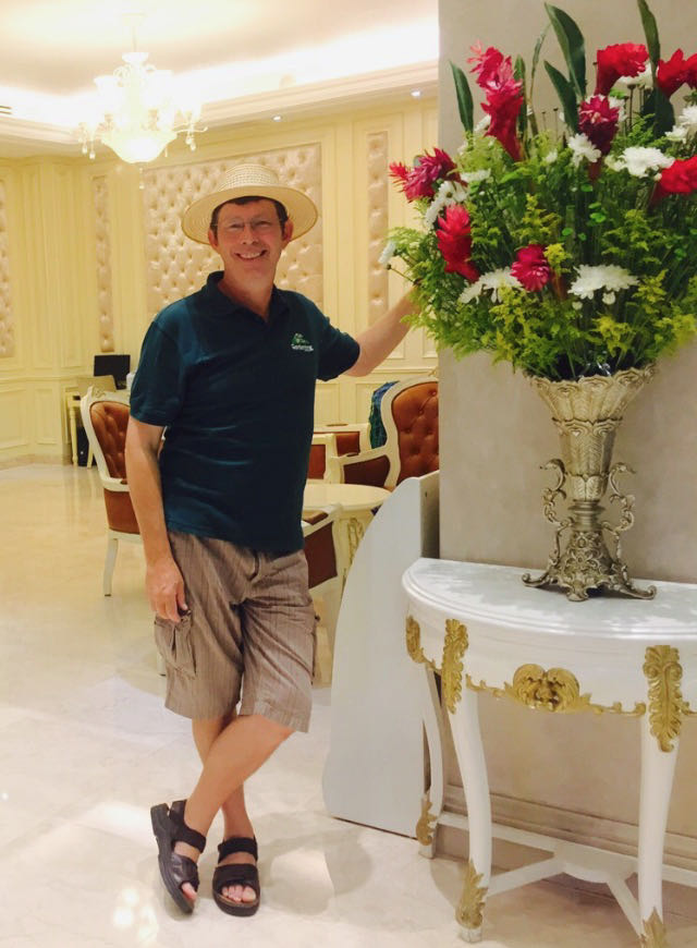 Author beside a vase display with gingers. 